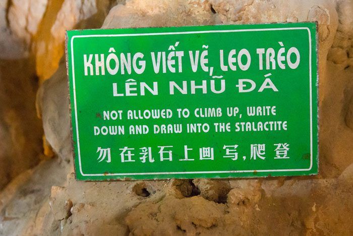 A sign in Vietnamese warning, "Not allowed to climb up, write down and draw into the stalactite."