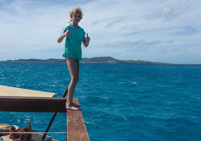 Kara giving a thumbs up before she jumps into the ocean from the upper level of Cloud 9 in Fiji.
