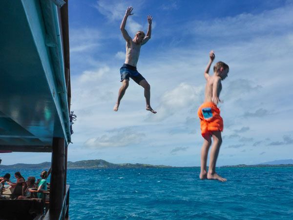 Tim and Tyler jumping into the ocean from the upper level of Cloud 9 in Fiji.