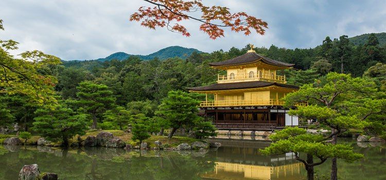Kinkaku-ji with a pagoda and trees around it