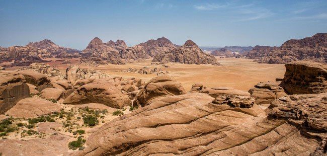 a desert landscape with rocky hills