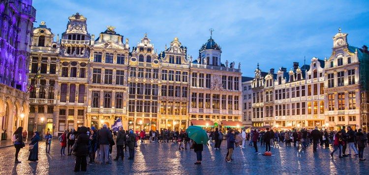 a group of people in front of Grand Place