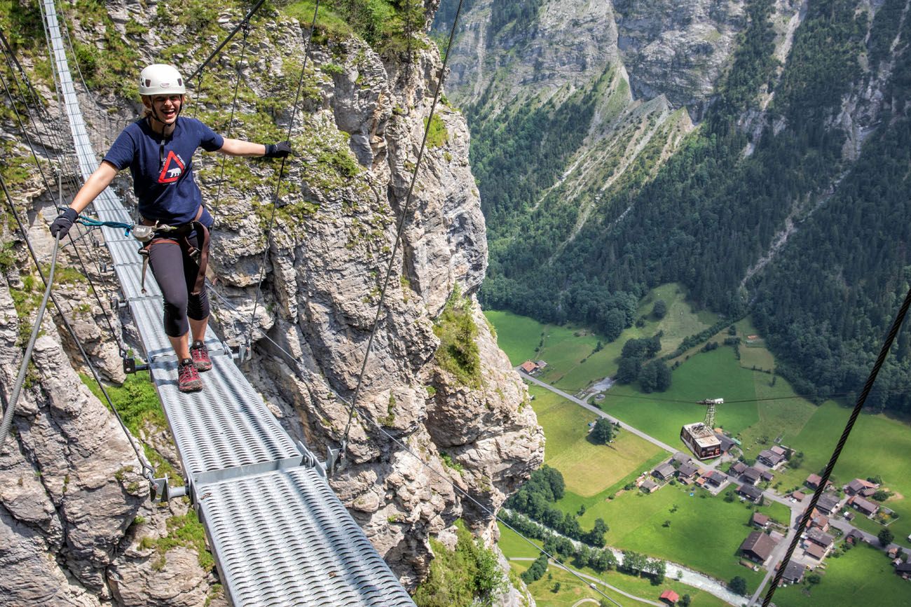 Steep steps on mountain path to the green alpine valley