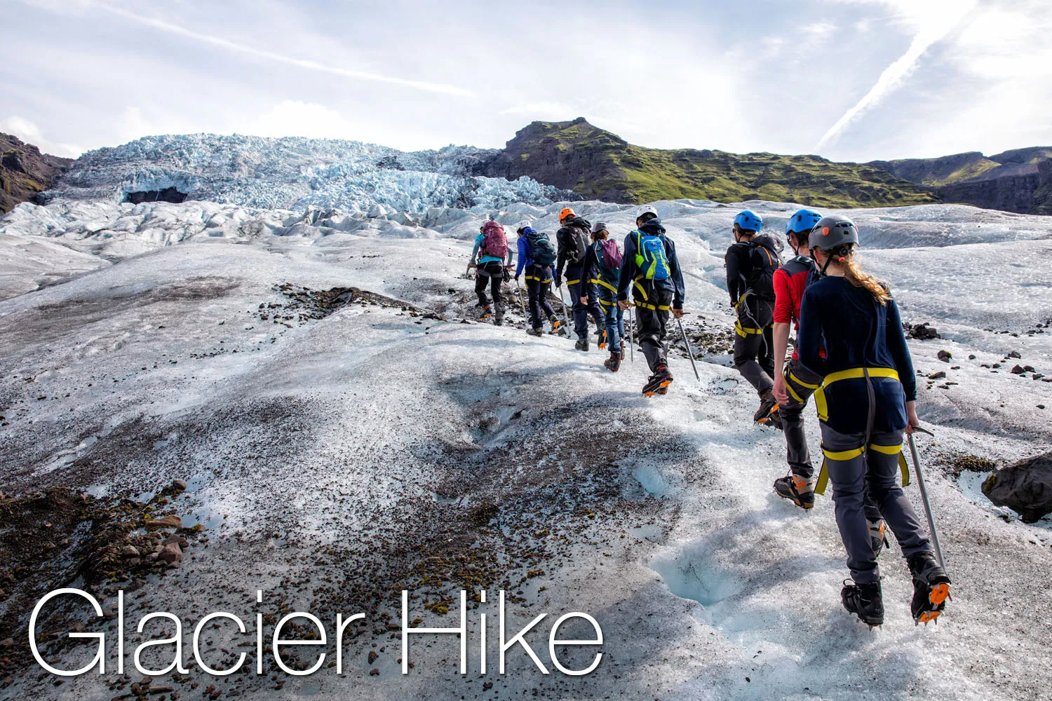 A group of hikers hiking up a glacier.