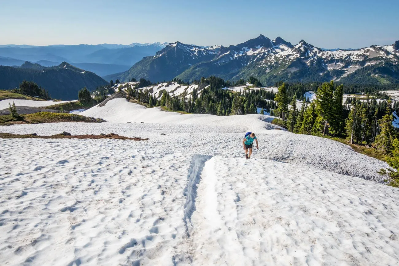 Kara hiking through snow on the Skyline Trail Loop in July