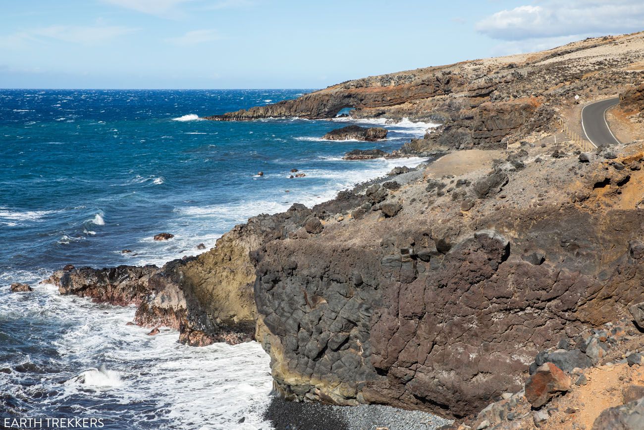 A Maui coastal view with a sea arch in the distance.