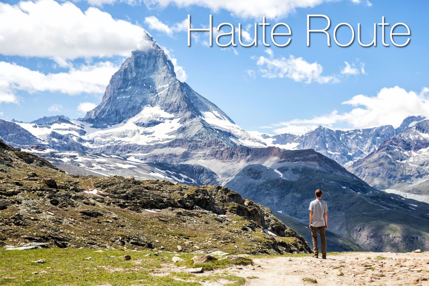 A man staring at a mountain while trekking on the Haute Route.