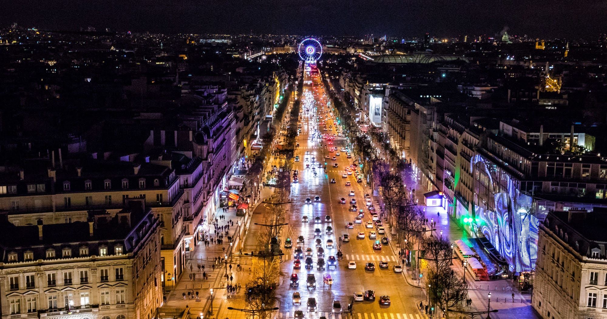Looking down the Champs-Elysees at night from the top of the Arc de Triomphe.